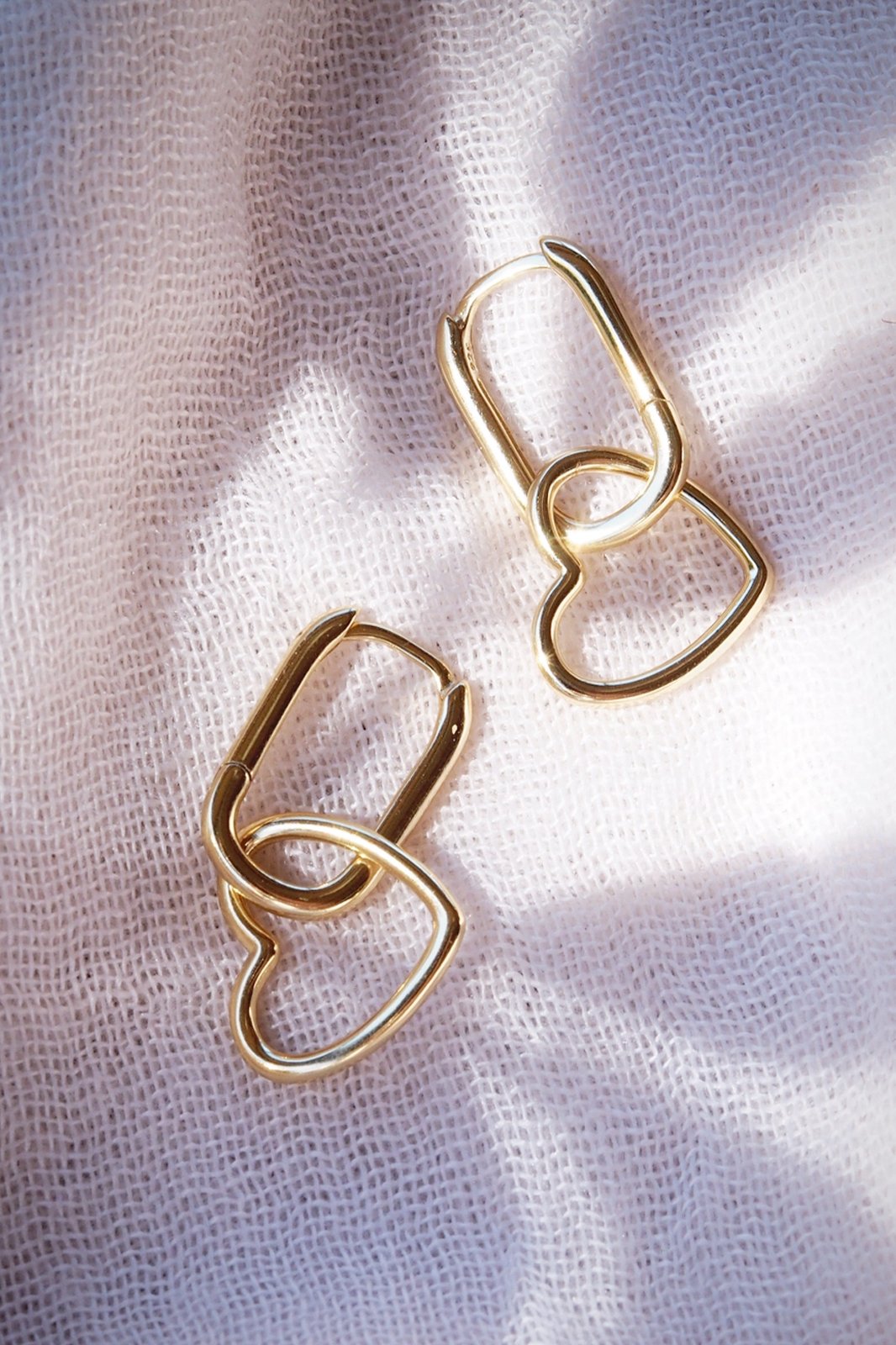 ELONGATED HEART HUGGIE HOOP EARRINGS - PU'UWAI - -